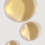 Close-up of three drops of cold-pressed prickly pear seed oil, highlighting its hydrating properties